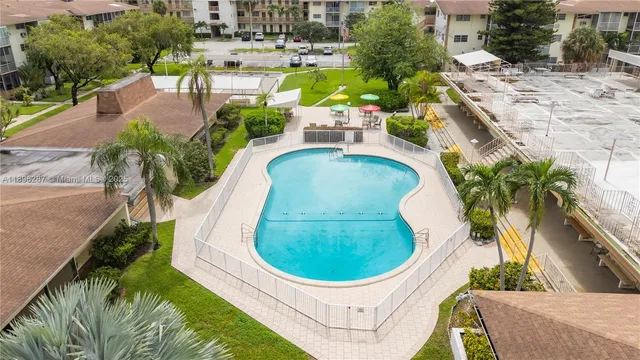 a view of a swimming pool with outdoor seating and plants