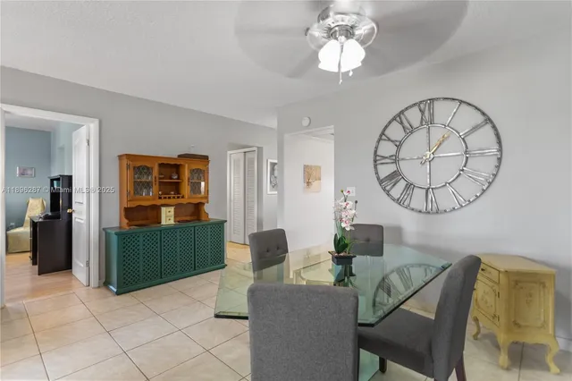 a living room with furniture a chandelier a mirror and a window