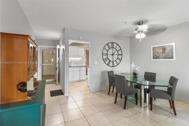 a view of a dining room with furniture and a chandelier