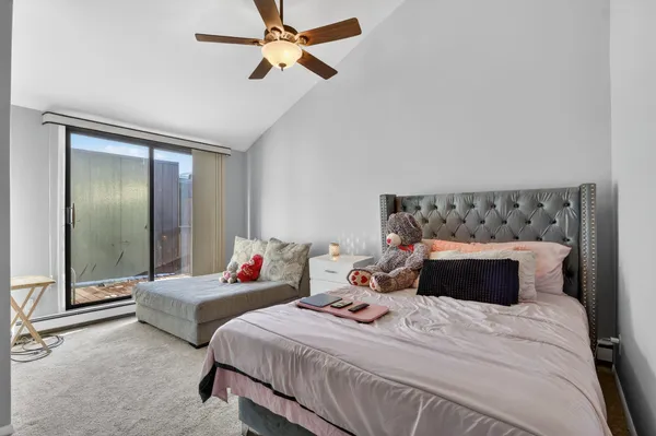 a kitchen with a refrigerator a dining table and chairs