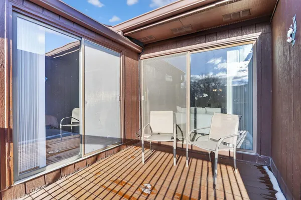 a living room with furniture a fireplace and a chandelier