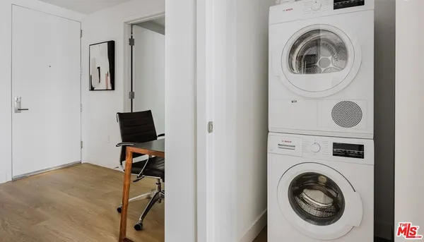 a view of a storage and utility room with washer and dryer