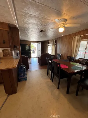 a living room with furniture a piano and a flat screen tv