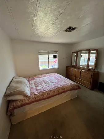 a bedroom with a bed and window