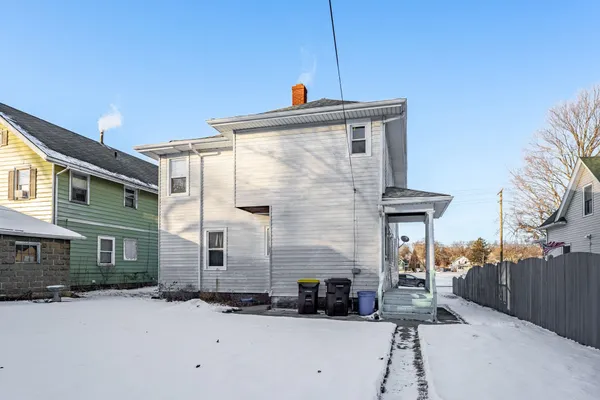 a view of a house with a snow in the yard