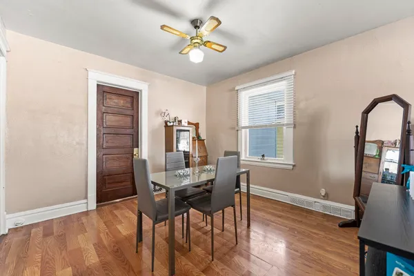 a bedroom with three beds and a chandelier