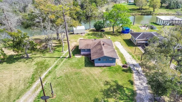 an aerial view of residential houses with outdoor space and swimming pool