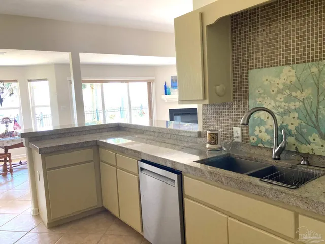 a kitchen with stainless steel appliances granite countertop a sink and a wooden cabinets