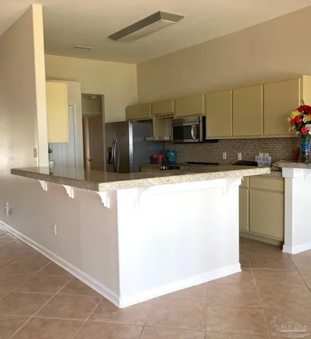 a kitchen with stainless steel appliances granite countertop a sink and a stove top oven