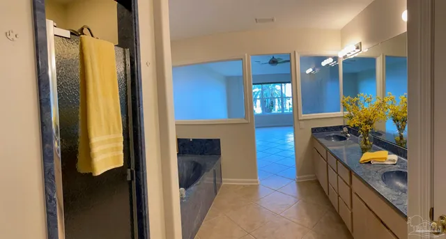 a bathroom with a sink a mirror and a shower