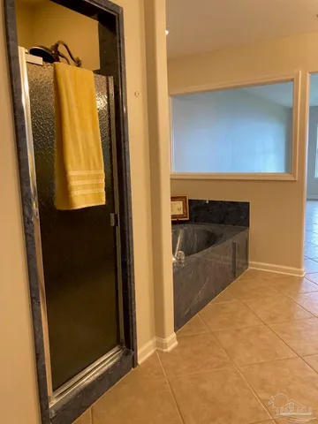 a bathroom with a tub and a shower