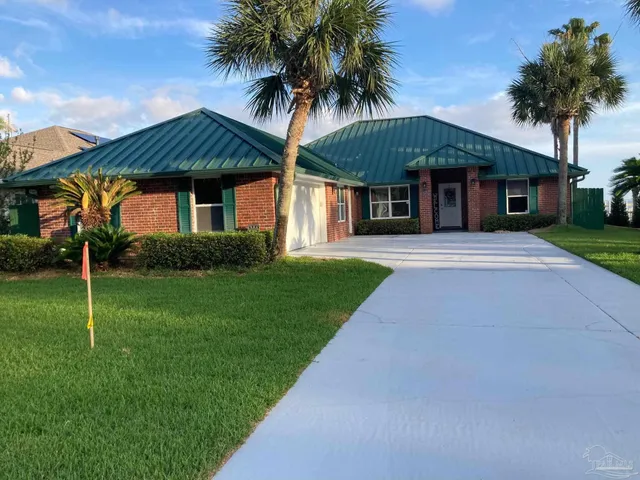 a front view of a house with a garden