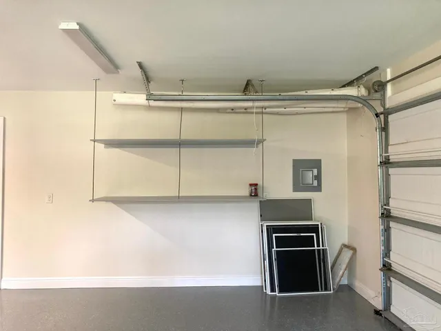 a kitchen with cabinets and a refrigerator