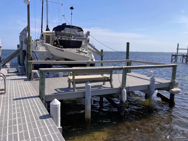 a view of a roof deck with table and chairs with wooden floor