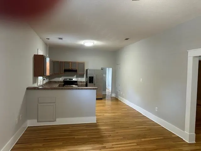 a kitchen with stainless steel appliances granite countertop a sink stove and refrigerator