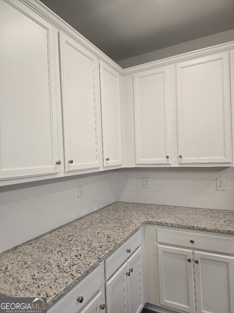 3405 Ripple Loop, Unit 127 Atlanta, GA 30349 - Photo 11 of 26 a kitchen with granite countertop white cabinets and granite counter tops