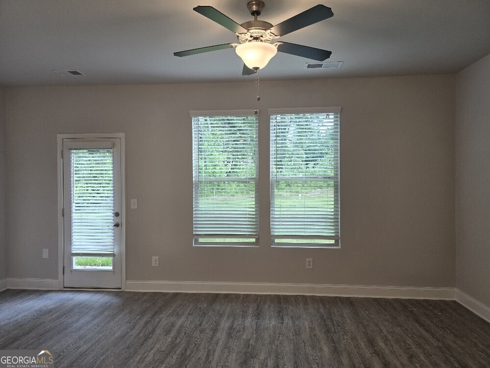3405 Ripple Loop, Unit 127 Atlanta, GA 30349 - Photo 15 of 26 a view of an empty room with wooden floor and a window