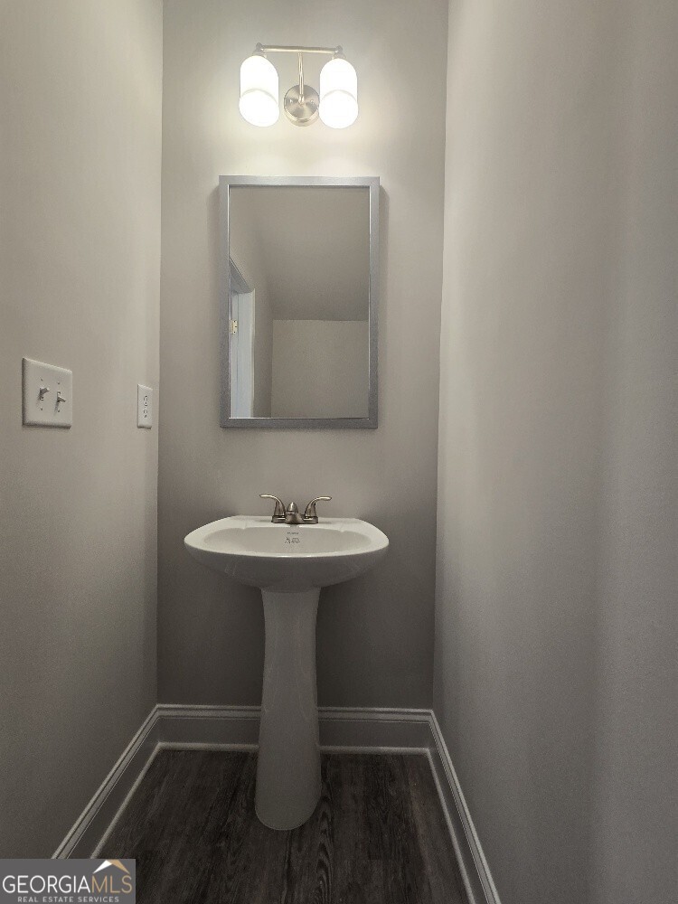 3405 Ripple Loop, Unit 127 Atlanta, GA 30349 - Photo 16 of 26 a bathroom with a sink toilet and mirror