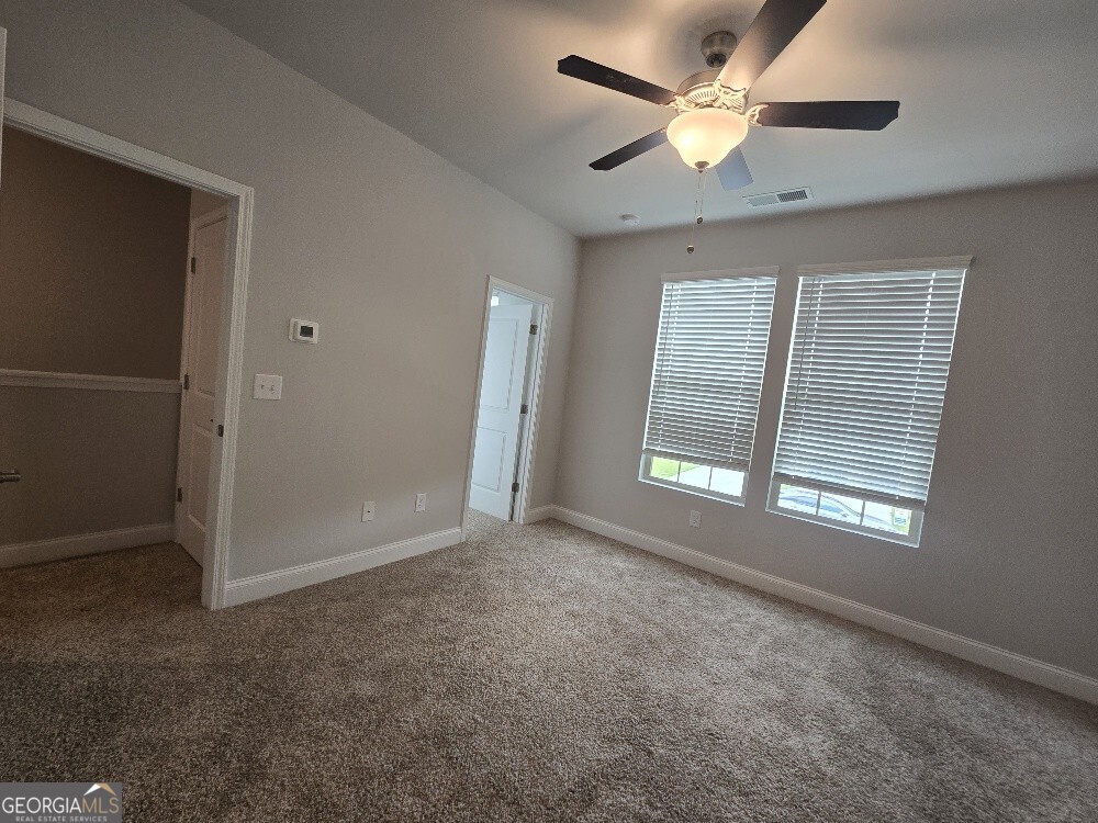 3405 Ripple Loop, Unit 127 Atlanta, GA 30349 - Photo 19 of 26 an empty room with windows and fan