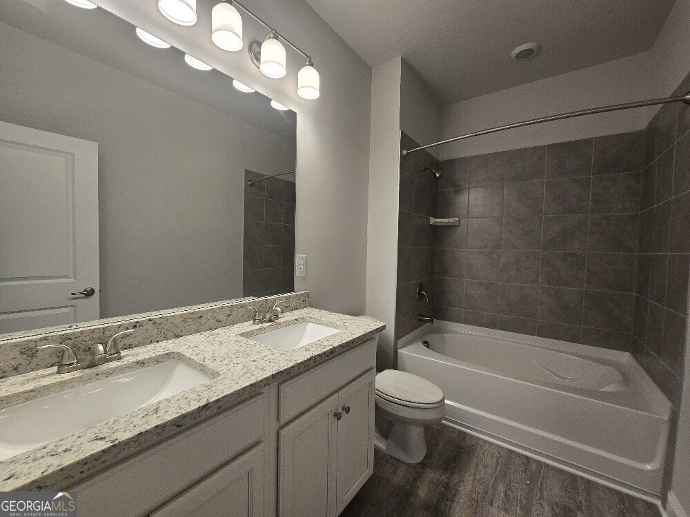 3405 Ripple Loop, Unit 127 Atlanta, GA 30349 - Photo 22 of 26 a bathroom with a granite countertop sink toilet and shower