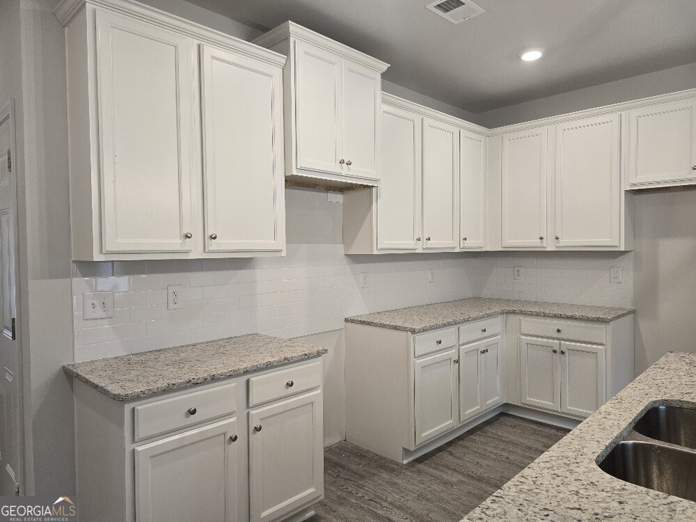 3405 Ripple Loop, Unit 127 Atlanta, GA 30349 - Photo 9 of 26 a kitchen with white cabinets and sink