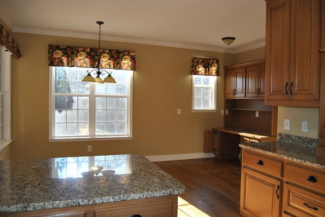 1399 Edge Road Forsyth, GA 31029 - Photo 11 of 31 a kitchen with granite countertop wooden cabinets and a granite counter top