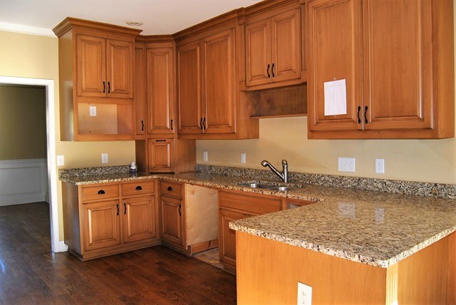 1399 Edge Road Forsyth, GA 31029 - Photo 13 of 31 a kitchen with granite countertop a sink stove and cabinets