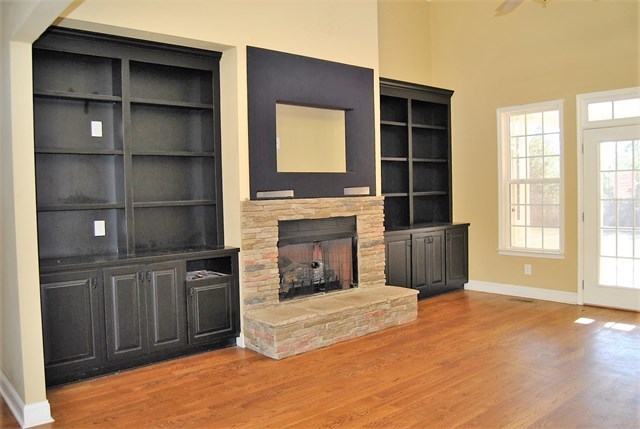 1399 Edge Road Forsyth, GA 31029 - Photo 5 of 31 a living room with a fireplace cabinet and a large window