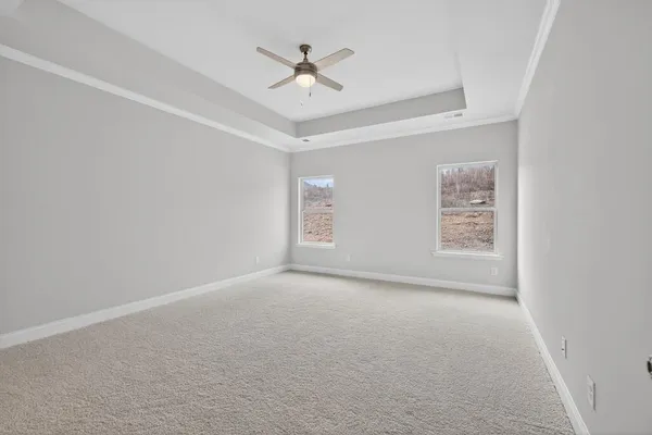 an empty room with a window and a ceiling fan