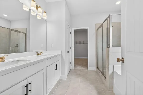 a spacious bathroom with a double vanity sink mirror and double