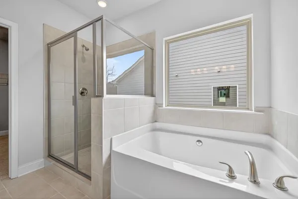 a bathroom with a tub and a shower