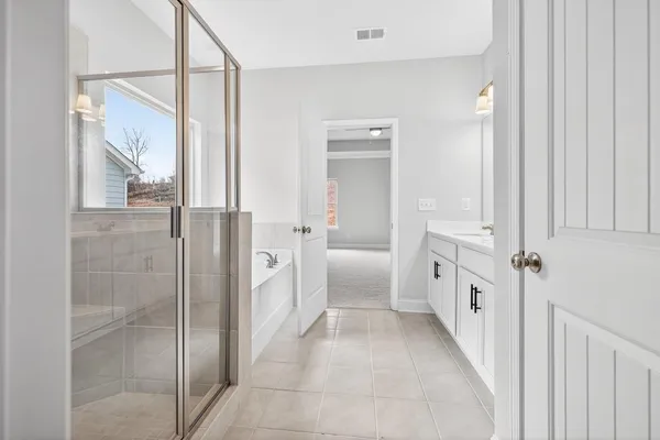 a bathroom with a tub and shower