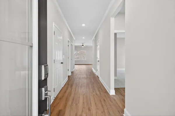 a view of a hallway with wooden floor