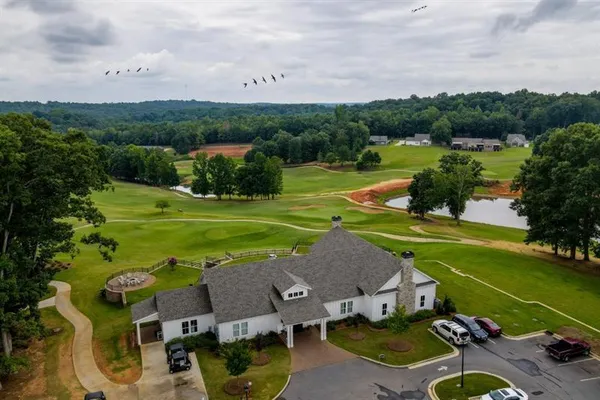an aerial view of a house with outdoor space and garden