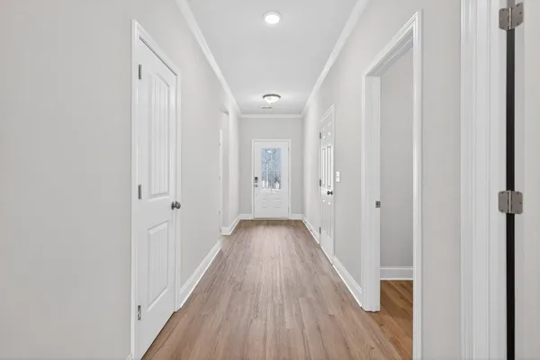 a view of a hallway with wooden floor