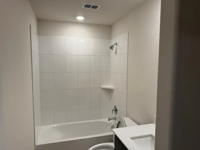 a bathroom with a bathtub and toilet