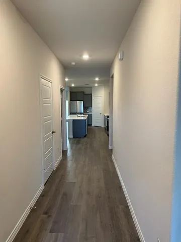 a view of livingroom with kitchen and wooden floor