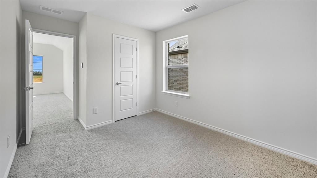 1203 Rusted Rail Drive Princeton, TX 75407 - Photo 14 of 37 Unfurnished bedroom featuring light colored carpet and multiple windows