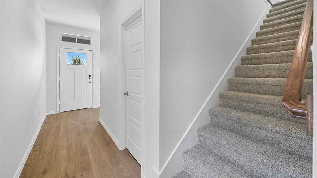 1203 Rusted Rail Drive Princeton, TX 75407 - Photo 18 of 37 Stairs featuring baseboards and wood finished floors