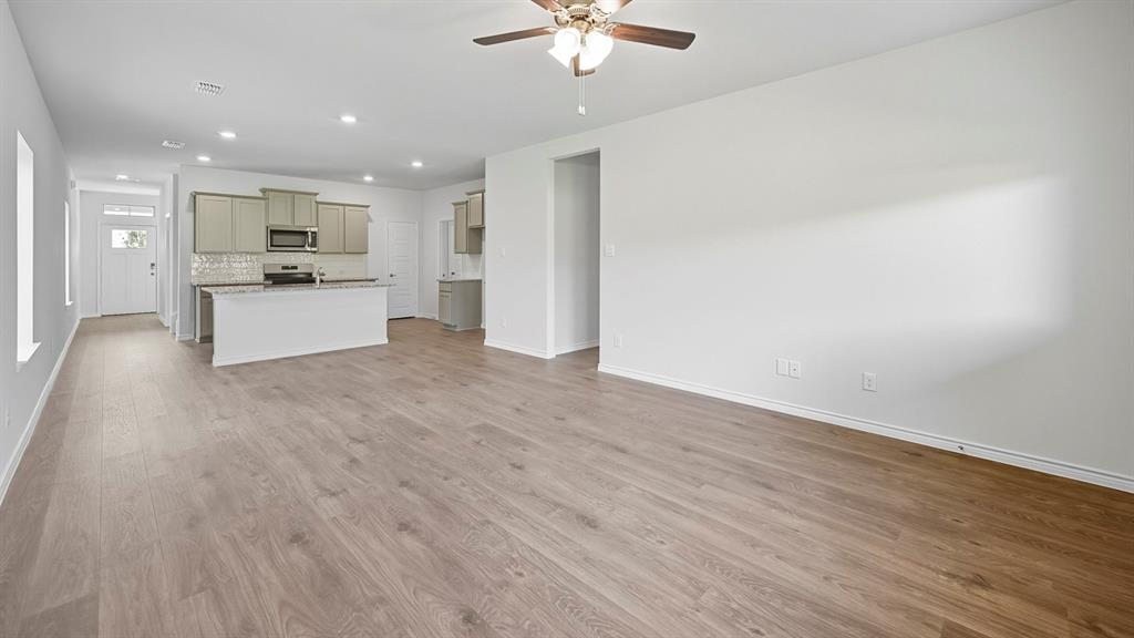1203 Rusted Rail Drive Princeton, TX 75407 - Photo 35 of 37 Unfurnished living room featuring recessed lighting, light wood finished floors, and ceiling fan