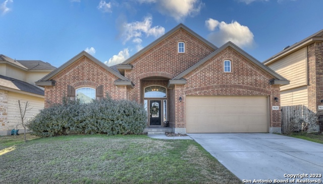 a front view of a house with a garden and plants