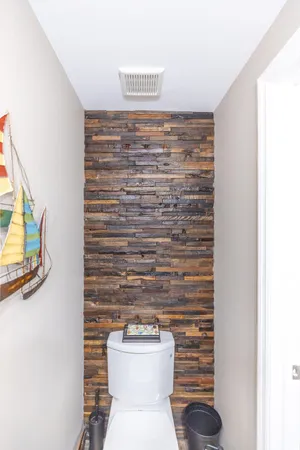 a bathroom with a toilet and a shower curtain