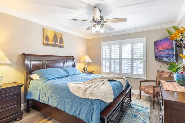 a bedroom with a bed and wooden floor