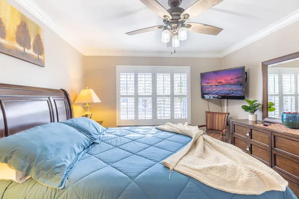 a bedroom with two beds and a chandelier