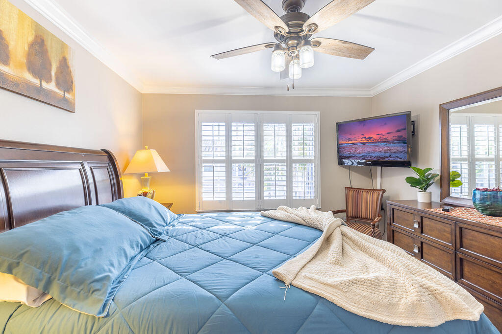 1038 Jeffery Street Boca Raton, FL 33487 - Photo 27 of 47 a bedroom with two beds and a chandelier