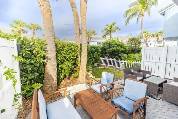a view of a patio with a table and chairs