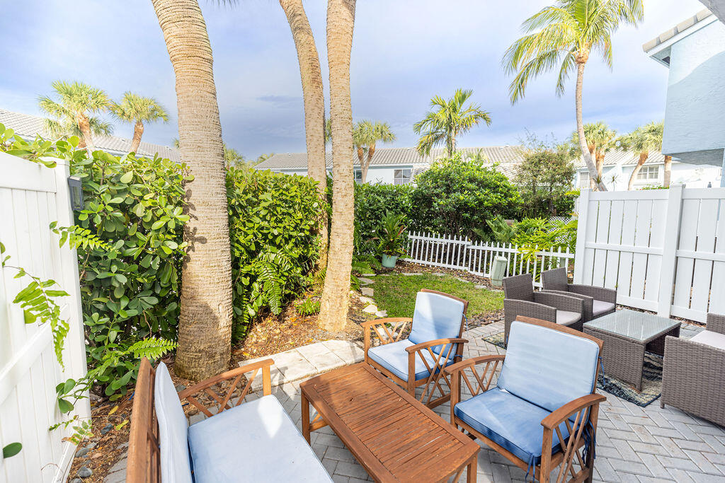 1038 Jeffery Street Boca Raton, FL 33487 - Photo 30 of 47 a view of a chairs and table in patio with wooden fence