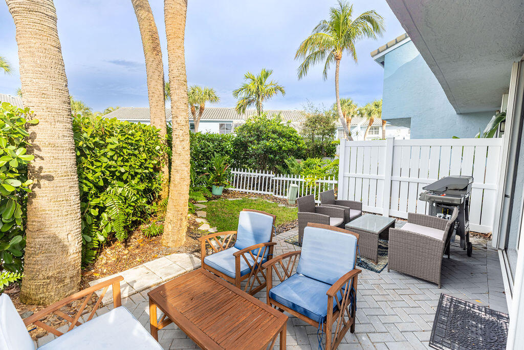 1038 Jeffery Street Boca Raton, FL 33487 - Photo 31 of 47 a view of a patio with a table and chairs