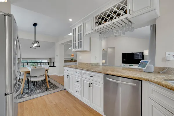 a kitchen with stainless steel appliances granite countertop a sink and cabinets