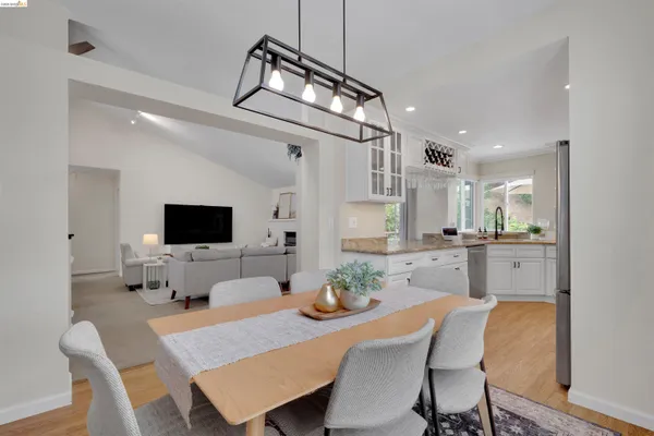 a view of a dining room with furniture and a flat screen tv